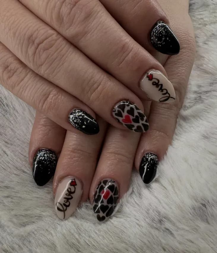 Black and red Valentine’s nails with hearts and lettering