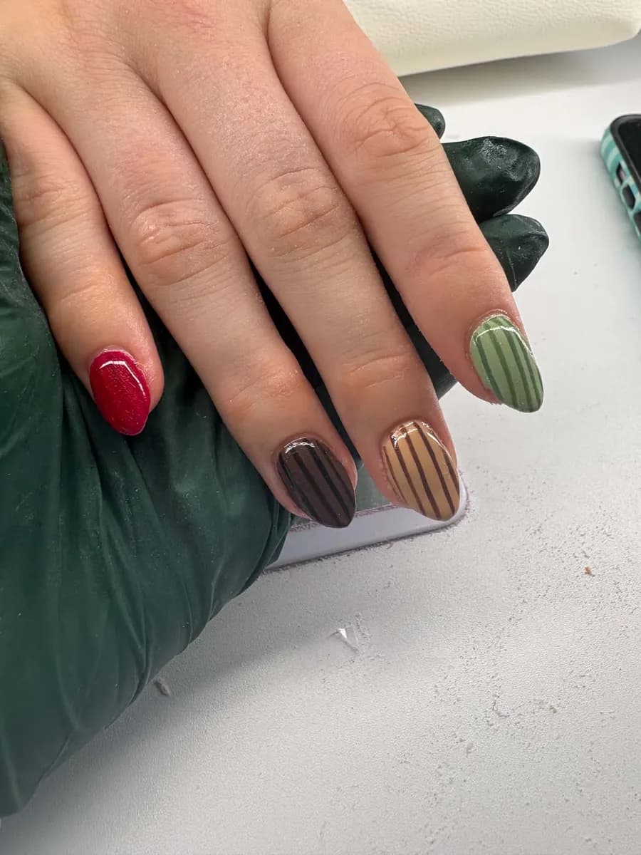 Red, chocolate and sage nails with hand-painted stripes