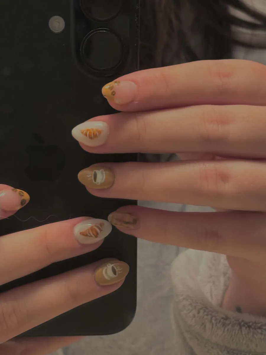 Nail art with tiny hand-painted croissants and coffee cups